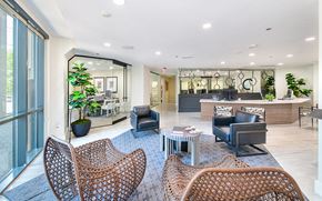 Dallas apartment for rent - the reserve at city center spacious lobby with tables and chairs