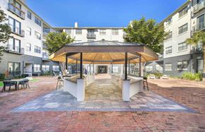 Dallas apartment for rent - an outdoor patio area with a gazebo at an apartment building
