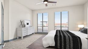 Richardson apartment for rent - a bedroom with a bed and two windows and a ceiling fan