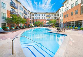Richardson apartment for rent - an outdoor swimming pool with an apartment building in the background