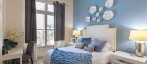 Frisco apartment for rent - a bedroom with blue walls and a white bed