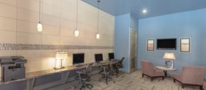 Frisco apartment for rent - a conference room with desks and chairs and a television
