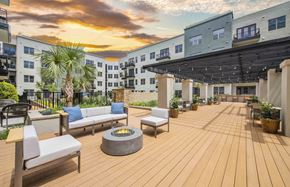 Dallas apartment for rent - the patio of an apartment building with a sunset in the background