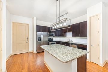 Dallas apartment for rent - A kitchen with a granite counter top and stainless steel appliances.