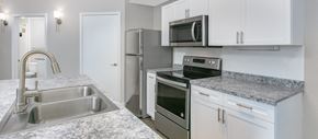 Plano apartment for rent - a kitchen with granite counter tops and stainless steel appliances
