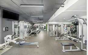 Dallas apartment for rent - A well-equipped gym with various exercise machines and weights.