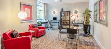 Dallas apartment for rent - a living room and dining room with red chairs and a glass table
