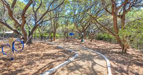 Austin apartment for rent - A playground with a blue swing set and a white slide.