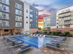 Austin apartment for rent - an apartment building with a swimming pool and lounge chairs