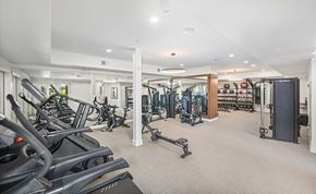 Austin apartment for rent - A spacious gym with a variety of equipment including treadmills, weights, and exercise machines.
