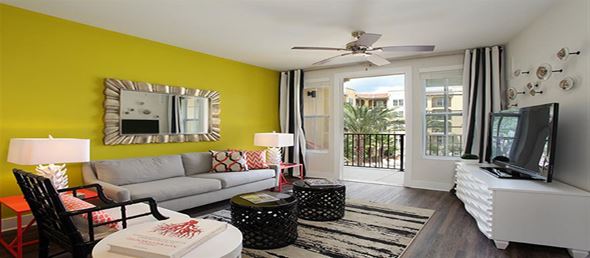 Tampa apartment for rent - a living room with a yellow wall and a television