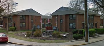 Nashville apartment for rent - a red brick building with a yard in front of it