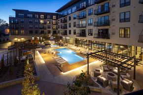 St. Louis Park apartment for rent - an apartment complex with a swimming pool at night