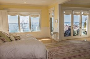 Harbor Springs house for rent - a bedroom with a bed and a view of the ocean