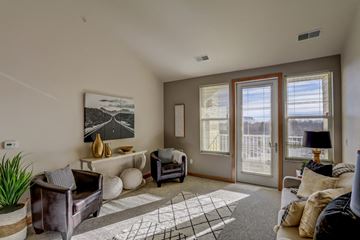 Sun Prairie apartment for rent - a living room with a couch and chairs and a door to a balcony