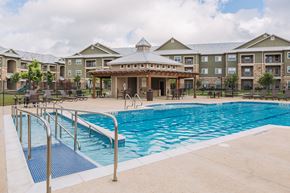 San Antonio apartment for rent - a swimming pool with a building in the background