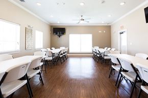 San Antonio apartment for rent - a conference room with white tables and chairs and a ceiling fan