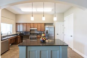 San Antonio apartment for rent - a kitchen with a blue island and a stainless steel refrigerator