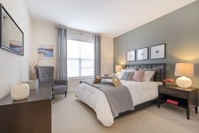 Burlington apartment for rent - a bedroom with a bed and a desk and a window