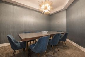Burlington apartment for rent - a dining room with a long wooden table and blue chairs