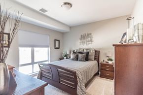 Bismarck apartment for rent - a bedroom with a bed and a dresser and a window