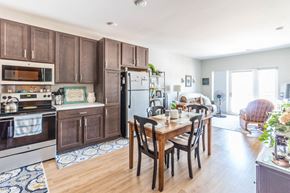 Bismarck apartment for rent - a kitchen with wooden cabinets and a wooden table