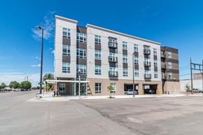Bismarck apartment for rent - a building with an empty parking lot in front of it