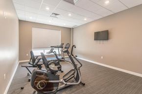 Bismarck apartment for rent - a gym with weights and a tv