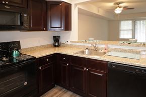 East Stroudsburg apartment for rent - a kitchen with wooden cabinets and granite counter tops and a sink