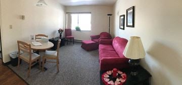 Manitowoc apartment for rent - a living room with a couch and a dining room table