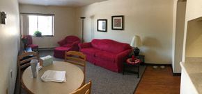 Manitowoc apartment for rent - a living room with a red couch and a table