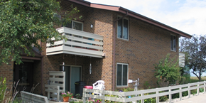 Cross Plains apartment for rent - a brick house with two balconies and a white fence