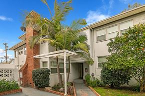 Los Angeles apartment for rent - an apartment building with a palm tree in front of it