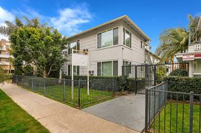 Los Angeles apartment for rent - an apartment building with a sidewalk and a fence in front of it