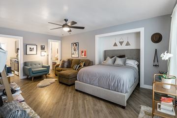 Los Angeles apartment for rent - a bedroom with a large bed and a living room with a couch