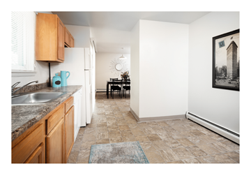 Bloomfield townhouse for rent - A kitchen with a table and chairs in the middle of the room.