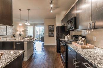 Granite kitchen countertops with ceramic tiled backsplash