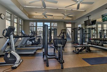 Professional 24-hour fitness center overlooking the pool