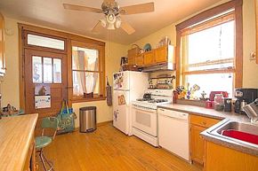 Chicago apartment for rent - A kitchen with a white refrigerator and a white stove.