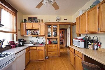 Chicago apartment for rent - A kitchen with wooden cabinets and a stove top oven.