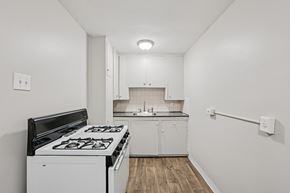 Denver apartment for rent - A white kitchen with a black stove top.