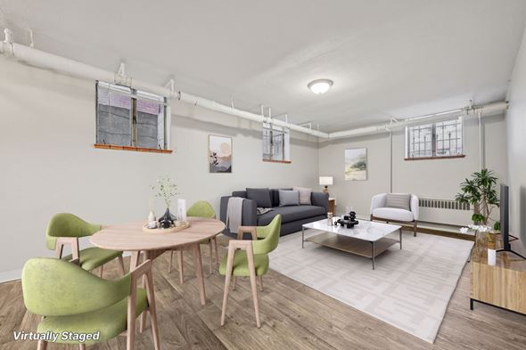 Denver apartment for rent - A living room with a green chair and a wooden table.