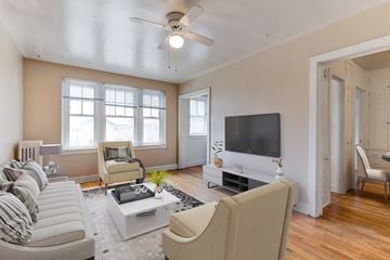 Denver apartment for rent - a living room with a ceiling fan and a tv