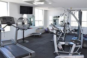 Denver apartment for rent - a gym with equipment and a tv in a room