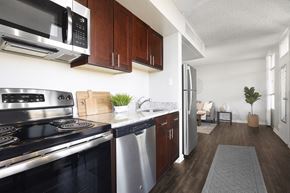 Denver apartment for rent - a kitchen with stainless steel appliances and wooden cabinets