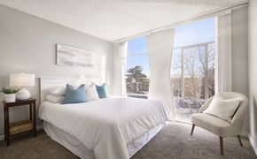 Denver apartment for rent - a bedroom with a bed and a large window