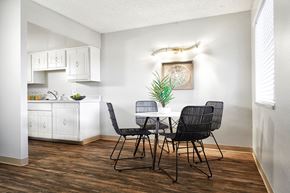 Littleton apartment for rent - a dining room with a table and chairs and a kitchen