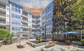 Atlanta apartment for rent - a courtyard with a fountain and patio furniture in front of an apartment building