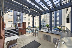 Atlanta apartment for rent - a communal area with tables and chairs and a kitchen and a pool