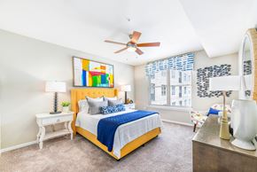 Atlanta apartment for rent - a bedroom with a yellow bed and a ceiling fan